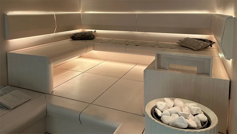 Reference indirect LED strip lighting beneath a sauna bench