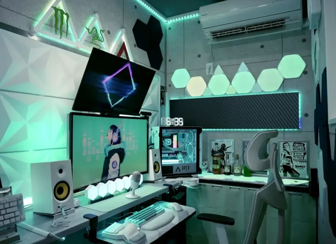 Gaming room with a desktop setup and layered blue and magenta LED lighting